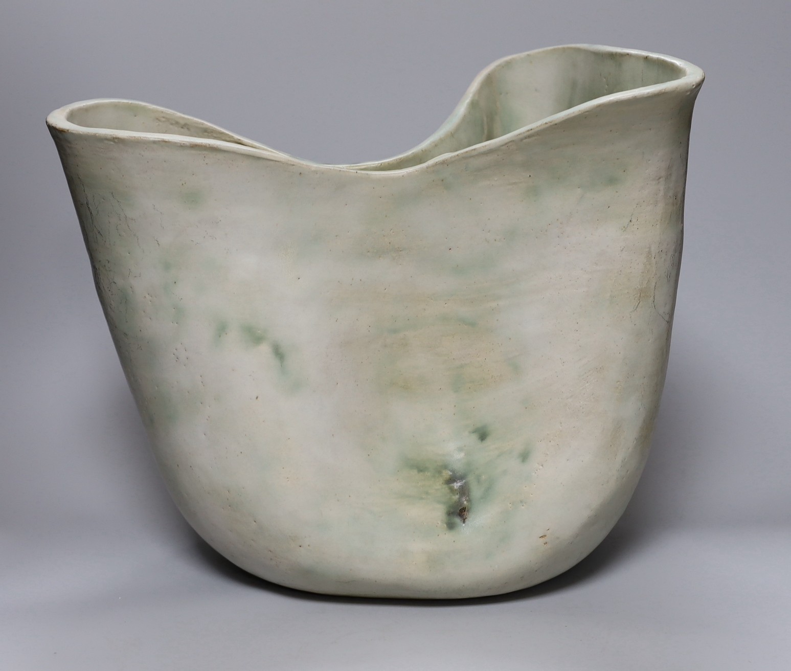 Ruth Sulke - a large studio stoneware white and green glazed free-form vase, 31cm